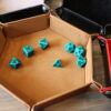 Brown dice tray with green dice
