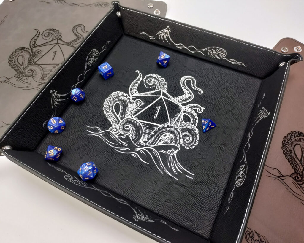 Dice tray with image of a kraken pulling d20 down into the sea